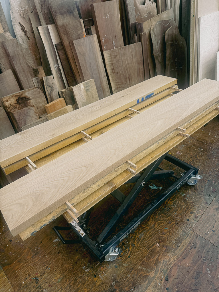 Oak lumber resting on strips to acclimate